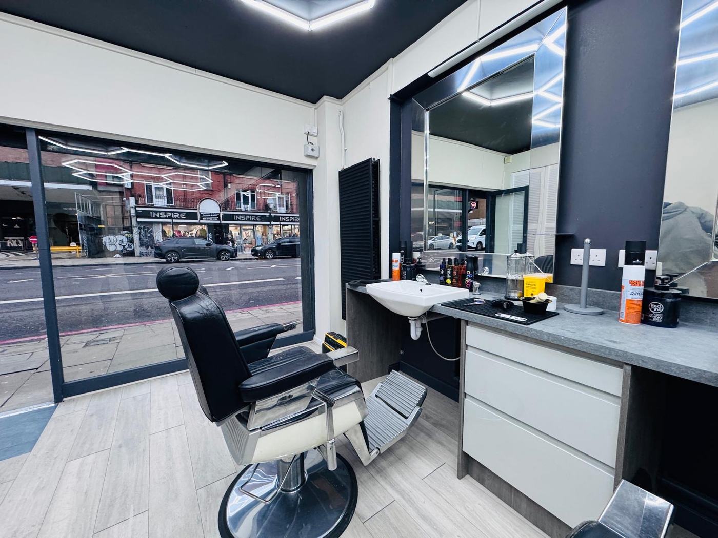 Barber chair by the window onto Commercial Road