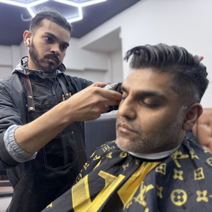 Barber finishing a textured crop with clippers